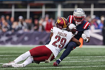 Nov 5, 2023; Foxborough, Massachusetts, USA; Washington Commanders cornerback Kendall Fuller (29) tackles New England Patriots receiver JuJu Smith-Schuster (7) during the second half at Gillette Stadium. Mandatory Credit: Paul Rutherford-USA TODAY Sports
