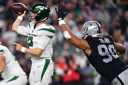 Nov 12, 2023; Paradise, Nevada, USA; New York Jets quarterback Zach Wilson (2) throws under pressure from Las Vegas Raiders defensive tackle Jerry Tillery (90) during the second half at Allegiant Stadium. Mandatory Credit: Gary A. Vasquez-USA TODAY Sports