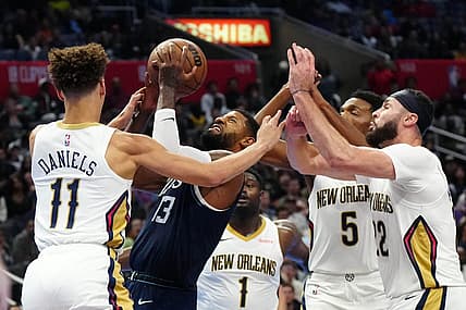 Nov 24, 2023; Los Angeles, California, USA; LA Clippers forward Paul George (13) shoots the ball against New Orleans Pelicans guard Dyson Daniels (11) and forwards Zion Williamson (1), Herbert Jones (5) and Larry Nance Jr. (22) in the second half at Crypto.com Arena. Mandatory Credit: Kirby Lee-USA TODAY Sports