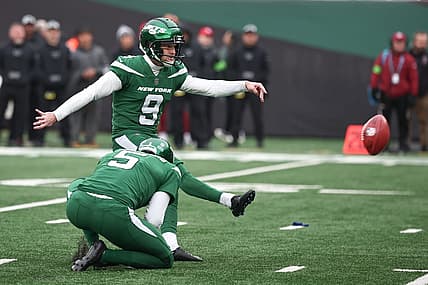 Dec 24, 2023; East Rutherford, New Jersey, USA; New York Jets place kicker Greg Zuerlein (9) kicks a field goal as punter Thomas Morstead (5) holds during the first half against the Washington Commanders at MetLife Stadium. Mandatory Credit: Vincent Carchietta-USA TODAY Sports