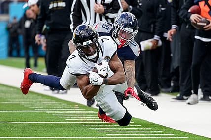Tennessee Titans cornerback Sean Murphy-Bunting (0) tackles Jacksonville Jaguars wide receiver Zay Jones (7) during the third quarter at Nissan Stadium in Nashville, Tenn., Sunday, Jan. 7, 2024.