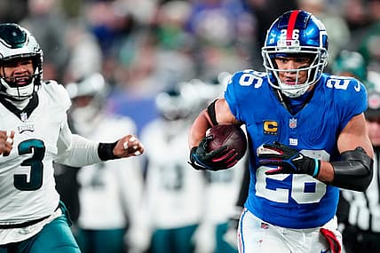 New York Giants running back Saquon Barkley (26) heads to the goal line in the second quarter past Philadelphia Eagles linebacker Nolan Smith (3), Sunday, January 7, 2024.