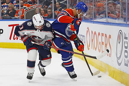 Jan 23, 2024; Edmonton, Alberta, CAN; Columbus Blue Jackets forward Johnny Gaudreau (13) and Edmonton Oilers defensemen Darnell Nurse (25) battle during the second period at Rogers Place. Mandatory Credit: Perry Nelson-USA TODAY Sports