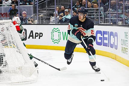 Feb 24, 2024; Seattle, Washington, USA; Seattle Kraken center Alex Wennberg (21) skates with the puck behind the net against the Minnesota Wild during the third period at Climate Pledge Arena. Mandatory Credit: Joe Nicholson-USA TODAY Sports