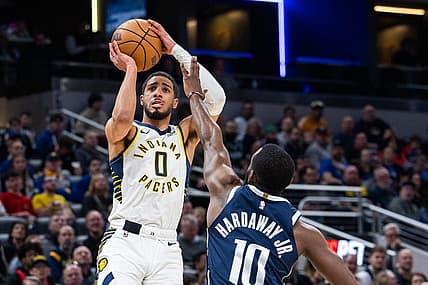 Feb 25, 2024; Indianapolis, Indiana, USA; Indiana Pacers guard Tyrese Haliburton (0) shoots the ball while Dallas Mavericks forward Tim Hardaway Jr. (10) defends in the first half at Gainbridge Fieldhouse. Mandatory Credit: Trevor Ruszkowski-USA TODAY Sports