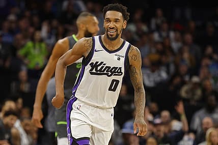 Mar 1, 2024; Minneapolis, Minnesota, USA; Sacramento Kings guard Malik Monk (0) celebrates his three-point basket against the Minnesota Timberwolves in overtime at Target Center. Mandatory Credit: Bruce Kluckhohn-USA TODAY Sports
