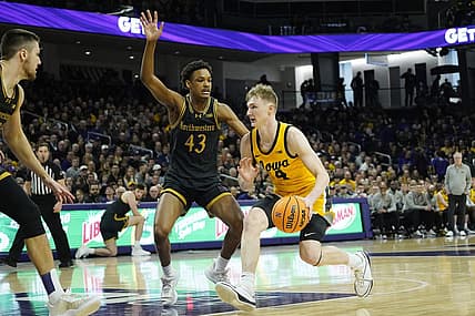 Mar 2, 2024; Evanston, Illinois, USA; Northwestern Wildcats guard Blake Smith (43) defends Iowa Hawkeyes guard Josh Dix (4) during the first half at Welsh-Ryan Arena. Mandatory Credit: David Banks-USA TODAY Sports