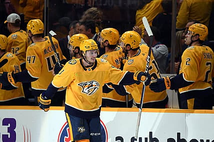 Mar 2, 2024; Nashville, Tennessee, USA; Nashville Predators center Cody Glass (8) celebrates with his teammates after a goal during the second period against the Colorado Avalanche at Bridgestone Arena. Mandatory Credit: Christopher Hanewinckel-USA TODAY Sports