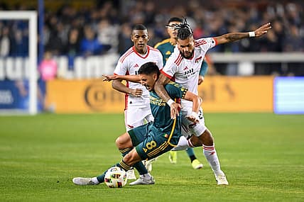 Mar 2, 2024; San Jose, California, USA; San Jose Earthquakes forward Will Richmond (20) battles for the ball against LA Galaxy midfielder Mark Delgado (8) during the first half at PayPal Park. Mandatory Credit: Robert Edwards-USA TODAY Sports