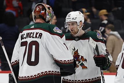 Mar 3, 2024; Washington, District of Columbia, USA; Arizona Coyotes goaltender Karel Vejmelka (70) celebrates with Coyotes defenseman J.J. Moser (90) after their game against the Washington Capitals at Capital One Arena. Mandatory Credit: Geoff Burke-USA TODAY Sports