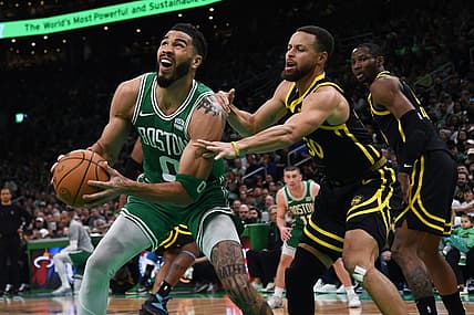 Mar 3, 2024; Boston, Massachusetts, USA;  Boston Celtics forward Jayson Tatum (0) controls the ball while Golden State Warriors guard Stephen Curry (30) defends during the first half at TD Garden. Mandatory Credit: Bob DeChiara-USA TODAY Sports