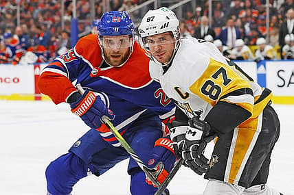 Mar 3, 2024; Edmonton, Alberta, CAN; Edmonton Oilers forward Leon Draisaitl (29) and Pittsburgh Penguins forward Sidney Crosby (87) look for a loose puck during the first period at Rogers Place. Mandatory Credit: Perry Nelson-USA TODAY Sports