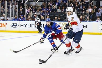 Mar 4, 2024; New York, New York, USA;  New York Rangers center Mika Zibanejad (93) and Florida Panthers center Sam Reinhart (13) chases the puck in the first period at Madison Square Garden. Mandatory Credit: Wendell Cruz-USA TODAY Sports