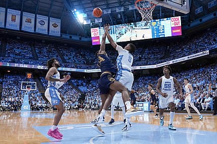 Mar 5, 2024; Chapel Hill, North Carolina, USA; Notre Dame Fighting Irish forward Kebba Njie (14) has his shot blocked by North Carolina Tar Heels forward Armando Bacot (5) during the first half at Dean E. Smith Center. Mandatory Credit: Jim Dedmon-USA TODAY Sports