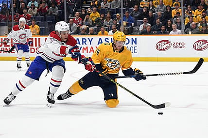 Mar 5, 2024; Nashville, Tennessee, USA; Nashville Predators center Gustav Nyquist (14) is played off the puck by Montreal Canadiens left wing Juraj Slafkovsky (20) during the first period at Bridgestone Arena. Mandatory Credit: Christopher Hanewinckel-USA TODAY Sports