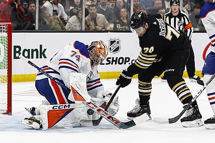 Mar 5, 2024; Boston, Massachusetts, USA; Boston Bruins left wing Jake DeBrusk (74) jams at a rebound at the crease of Edmonton Oilers goaltender Stuart Skinner (74) during the second period at TD Garden. Mandatory Credit: Winslow Townson-USA TODAY Sports