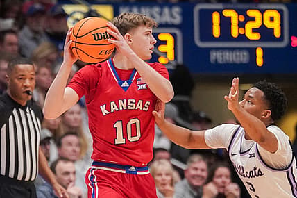 Mar 5, 2024; Lawrence, Kansas, USA; Kansas Jayhawks guard Johnny Furphy (10) looks to pass as Kansas State Wildcats guard Tylor Perry (2) defends during the first half at Allen Fieldhouse. Mandatory Credit: Denny Medley-USA TODAY Sports
