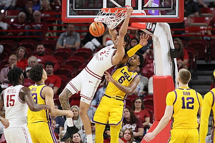 Mar 6, 2024; Fayetteville, Arkansas, USA; Arkansas Razorbacks forward Trevon Brazile (2) dunks the ball in the first half as LSU Tigers guard Jordan Wright (6) defends at Bud Walton Arena. Mandatory Credit: Nelson Chenault-USA TODAY Sports