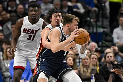 Mar 7, 2024; Dallas, Texas, USA; Miami Heat guard Jaime Jaquez Jr. (11) attempts to knock the ball away from Dallas Mavericks guard Luka Doncic (77) during the first half at the American Airlines Center. Mandatory Credit: Jerome Miron-USA TODAY Sports