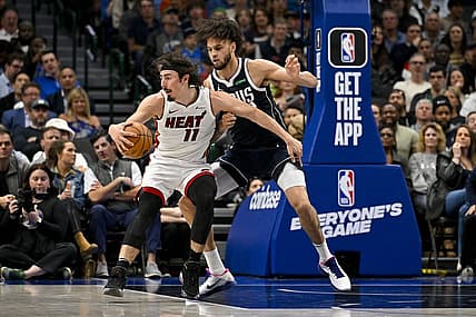 Mar 7, 2024; Dallas, Texas, USA; Miami Heat guard Jaime Jaquez Jr. (11) looks to move the ball past Dallas Mavericks center Dereck Lively II (2) during the second half at the American Airlines Center. Mandatory Credit: Jerome Miron-USA TODAY Sports