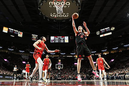 Mar 9, 2024; Portland, Oregon, USA; Toronto Raptors power forward Kelly Olynyk (41) shoots the ball as Portland Trail Blazers guard Dalano Banton (5) looks on during the first half at Moda Center. Mandatory Credit: Soobum Im-USA TODAY Sports