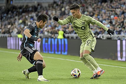 Mar 16, 2024; Saint Paul, Minnesota, USA;  Los Angeles FC midfielder Eduard Atuesta (20) controls the ball as Minnesota United FC forward Jeong Sang-Bin (11) defends during the first half at Allianz Field. Mandatory Credit: Nick Wosika-USA TODAY Sports