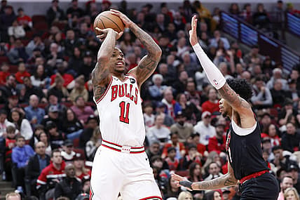 Mar 18, 2024; Chicago, Illinois, USA; Chicago Bulls forward DeMar DeRozan (11) shoots against Portland Trail Blazers guard Anfernee Simons (1) during the first half at United Center. Mandatory Credit: Kamil Krzaczynski-USA TODAY Sports