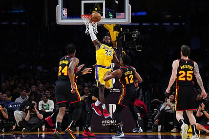 Mar 18, 2024; Los Angeles, California, USA; Los Angeles Lakers forward LeBron James (23) reaches for the ball against Atlanta Hawks forward Bruno Fernando (24), Atlanta Hawks forward De'Andre Hunter (12) and guard Garrison Mathews (25) in the first half at Crypto.com Arena. Mandatory Credit: Kirby Lee-USA TODAY Sports