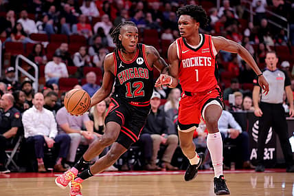 Mar 21, 2024; Houston, Texas, USA; Chicago Bulls guard Ayo Dosunmu (12) handles the ball against Houston Rockets forward Amen Thompson (1) during the second quarter at Toyota Center. Mandatory Credit: Erik Williams-USA TODAY Sports