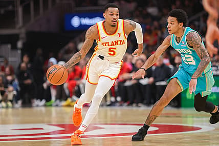 Mar 23, 2024; Atlanta, Georgia, USA; Atlanta Hawks guard Dejounte Murray (5) is defended by Charlotte Hornets guard Tre Mann (23) in the first quarter at State Farm Arena. Mandatory Credit: Brett Davis-USA TODAY Sports