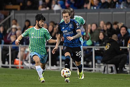 Mar 23, 2024; San Jose, California, USA; San Jose Earthquakes forward Benji Kikanovic (28) dribbles the ball while Seattle Sounders FC midfielder Dylan Teves (99) defends during the second half at PayPal Park. Mandatory Credit: Stan Szeto-USA TODAY Sports