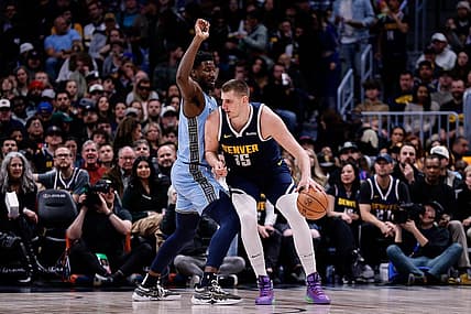 Mar 25, 2024; Denver, Colorado, USA; Denver Nuggets center Nikola Jokic (15) controls the ball against Memphis Grizzlies forward Jaren Jackson Jr. (13) in the second quarter at Ball Arena. Mandatory Credit: Isaiah J. Downing-USA TODAY Sports