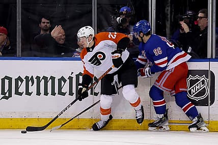 Mar 26, 2024; New York, New York, USA; Philadelphia Flyers defenseman Ronnie Attard (23) looks to pass the puck against New York Rangers center Jack Roslovic (96) during the first period at Madison Square Garden. Mandatory Credit: Brad Penner-USA TODAY Sports