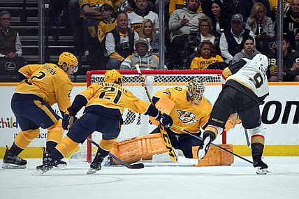 Mar 26, 2024; Nashville, Tennessee, USA; Nashville Predators goaltender Juuse Saros (74) makes a save on a shot by Vegas Golden Knights center Jack Eichel (9) during the first period at Bridgestone Arena. Mandatory Credit: Christopher Hanewinckel-USA TODAY Sports