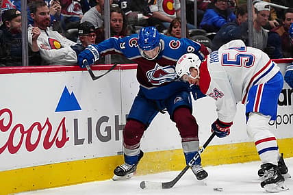 Mar 26, 2024; Denver, Colorado, USA; Montreal Canadiens defenseman Jordan Harris (54) and Colorado Avalanche left wing Zach Parise (9) battle for the puck in the first period at Ball Arena. Mandatory Credit: Ron Chenoy-USA TODAY Sports
