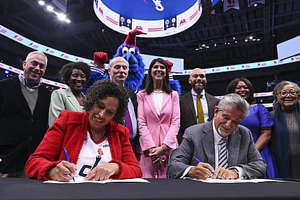 Mar 27, 2024; Washington, District of Columbia, USA;  Washington DC mayor Muriel Bowser  and Monumental Sports & Entertainment CEO Ted Leonsis sign an agreement on the court before the game between the Brooklyn Nets and the Washington Wizards at Capital One Arena. Mandatory Credit: Tommy Gilligan-USA TODAY Sports