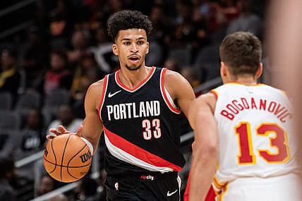 Mar 27, 2024; Atlanta, Georgia, USA; Portland Trail Blazers forward Toumani Camara (33) dribbles the ball against Atlanta Hawks guard Bogdan Bogdanovic (13) during the first quarter at State Farm Arena. Mandatory Credit: Jordan Godfree-USA TODAY Sports