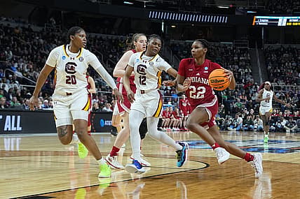 Mar 29, 2024; Albany, NY, USA; Indiana Hoosiers guard Chloe Moore-McNeil (22) drives the ball against South Carolina Gamecocks guard MiLaysia Fulwiley (12) and  forward Sania Feagin (20) during the first half in the semifinals of the Albany Regional of the 2024 NCAA Tournament at the MVP Arena at MVP Arena. Mandatory Credit: Gregory Fisher-USA TODAY Sports