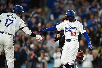 Mar 29, 2024; Los Angeles, California, USA; Los Angeles Dodgers second baseman Mookie Betts (50) high fives designated hitter Shohei Ohtani (17)after hitting a home run against the St. Louis Cardinals during the first inning at Dodger Stadium. Mandatory Credit: Jonathan Hui-USA TODAY Sports