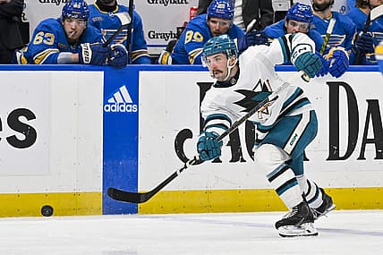 Mar 30, 2024; St. Louis, Missouri, USA;  San Jose Sharks defenseman Kyle Burroughs (4) shoots against the St. Louis Blues during the third period at Enterprise Center. Mandatory Credit: Jeff Curry-USA TODAY Sports