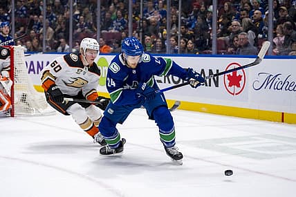 Mar 31, 2024; Vancouver, British Columbia, CAN; Anaheim Ducks defenseman Jackson LaCombe (60) defends against Vancouver Canucks forward Pius Suter (24) in the first period at Rogers Arena. Mandatory Credit: Bob Frid-USA TODAY Sports