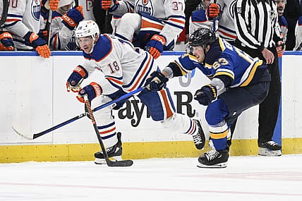 Apr 1, 2024; St. Louis, Missouri, USA; St. Louis Blues left wing Jake Neighbours (63) pressures Edmonton Oilers left wing Zach Hyman (18) during the third period at Enterprise Center. Mandatory Credit: Jeff Le-USA TODAY Sports
