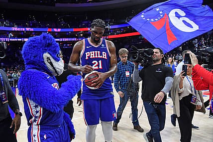 Apr 2, 2024; Philadelphia, Pennsylvania, USA; Philadelphia 76ers center Joel Embiid (21) autographs a basketball as he celebrates win against the Oklahoma City Thunder at Wells Fargo Center. Mandatory Credit: Eric Hartline-USA TODAY Sports