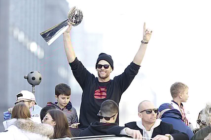 Tom Brady holds the Lombardi Trophy