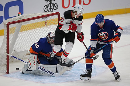 Jan 21, 2021; Uniondale, New York, USA; New York Islanders goalie Semyon Varlamov (40) makes a save against New Jersey Devils center Jesper Boqvist (90) in front of Islanders defenseman Ryan Pulock (6) during the first period at Nassau Veterans Memorial Coliseum. Mandatory Credit: Brad Penner-USA TODAY Sports