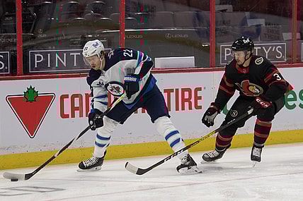Jan 21, 2021; Ottawa, Ontario, CAN; Winnipeg Jets center Mason Appleton (22) skates with the puck in front of  Ottawa Senators defenseman Josh Brown (3) in the first period at the Canadian Tire Centre. Mandatory Credit: Marc DesRosiers-USA TODAY Sports