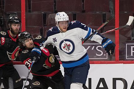 Jan 21, 2021; Ottawa, Ontario, CAN; Ottawa Senators center Colin White (36) is checked by Winnipeg Jets center Andrew Copp (9) in the second period at the Canadian Tire Centre. Mandatory Credit: Marc DesRosiers-USA TODAY Sports