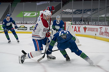 Jan 23, 2021; Vancouver, British Columbia, CAN; Vancouver Canucks defenseman Quinn Hughes (43) checks Montreal Canadiens forward Corey Perry (94) in the first period at Rogers Arena. Mandatory Credit: Bob Frid-USA TODAY Sports