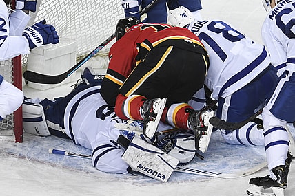 Jan 24, 2021; Calgary, Alberta, CAN; Calgary Flames forward Matthew Tkachuk (19) ends up on top of Toronto Maple Leafs goalie Jack Campbell (36) during the third period at Scotiabank Saddledome. Mandatory Credit: Candice Ward-USA TODAY Sports