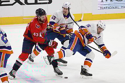 Jan 28, 2021; Washington, District of Columbia, USA; Washington Capitals right wing Tom Wilson (43) trips New York Islanders right wing Cal Clutterbuck (15) while battling for the puck in the first period at Capital One Arena. Mandatory Credit: Geoff Burke-USA TODAY Sports